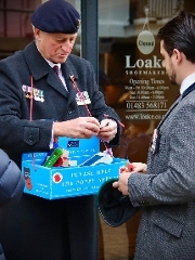 Poppy Appeal collector wearing beret and medals